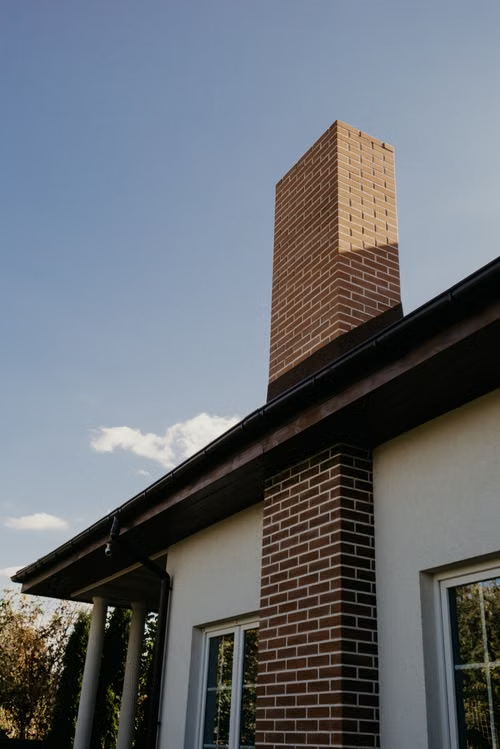 Brick chimney at the corner of a house in need of chimney repair